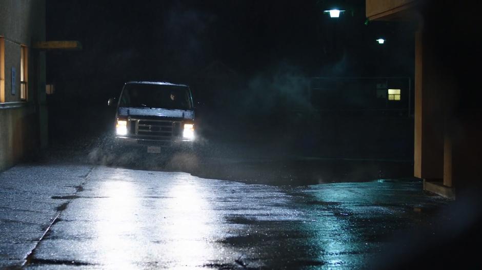 A van pulls up to the front of the A.R.G.U.S. building.