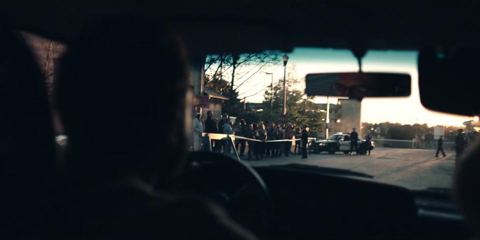 Luke drives up to the front of the hospital where the police are holding off swarms off protestors.