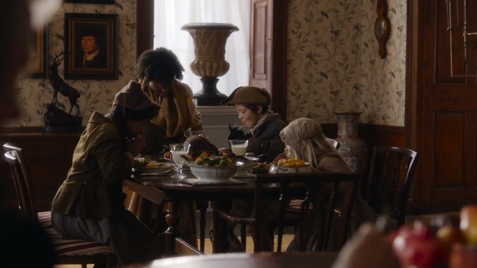 The four urchins dig in to a delicious looking meal set for them on the table.