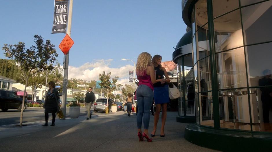 Candy and Charlotte talk about engagement rings out front of the shop.