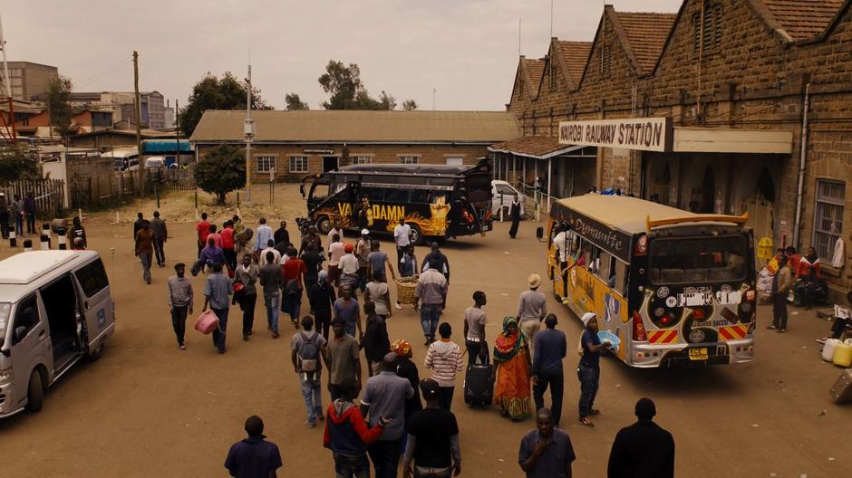 The Van Damn pulls to a stop in front of the railway station while a number of people mill around.