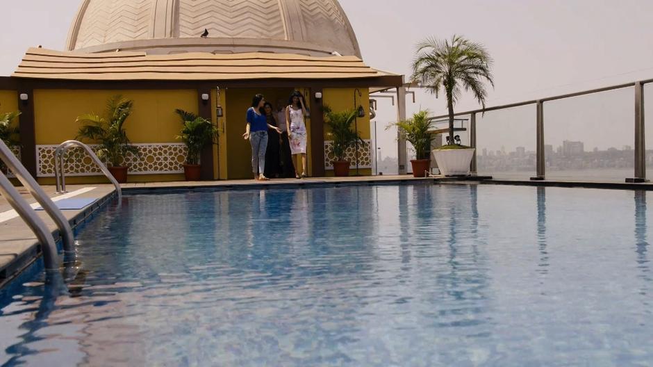 Kala's sister reacts to the pool on the roof as the rest of the family walks up behind them.