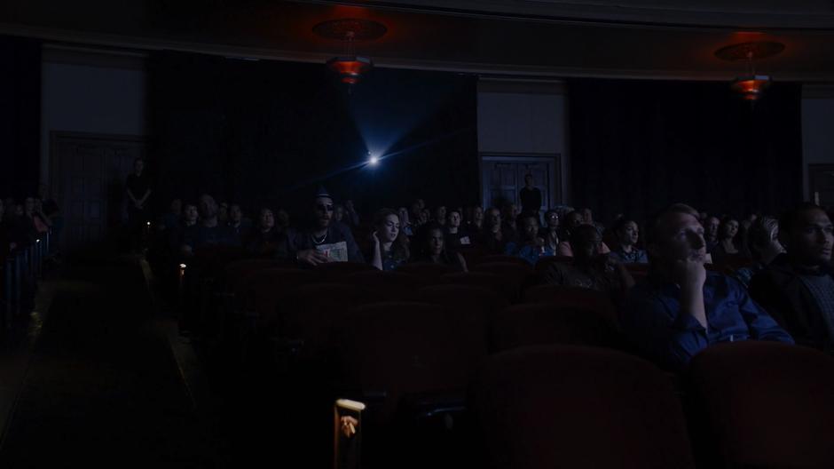 Bug, Nomi, & Amanita settle into their seats in the fairly crowded theatre.