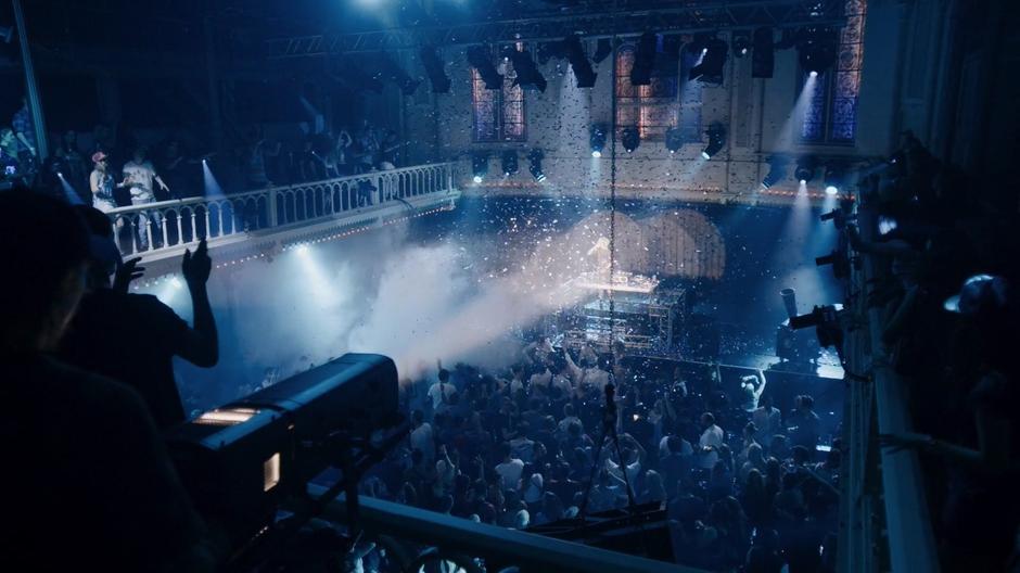 Confetti flies through the air as the people in the club dance to Riley's set.