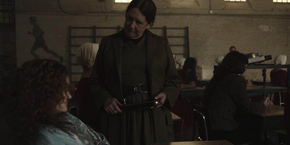 Aunt Lydia gives Janine a stern look after she mouthed off in class.