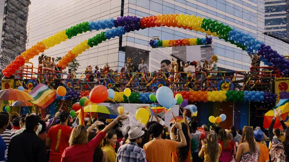 The MC hands the microphone over to Lito who looks out over the crowd from atop the float.