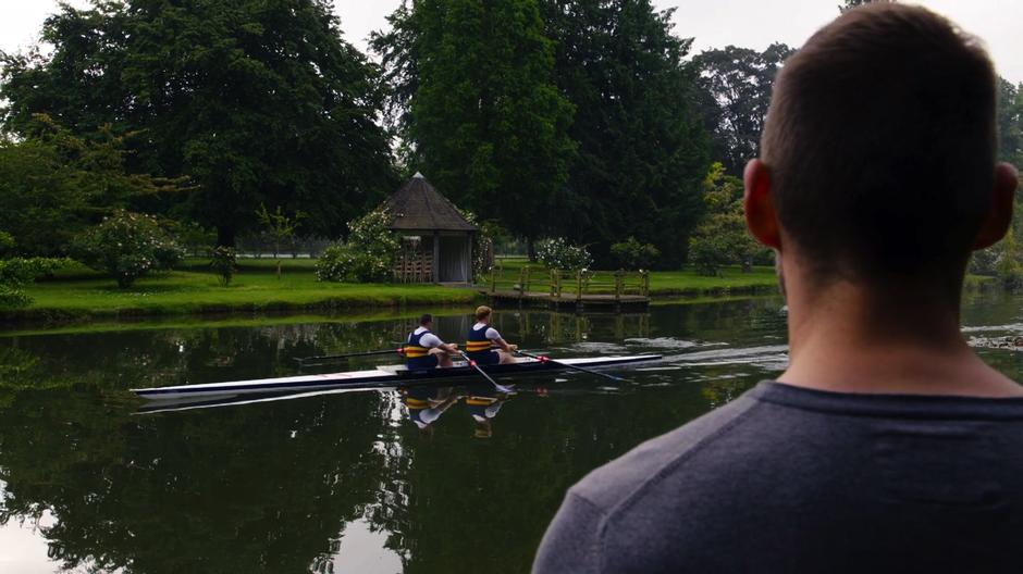 Will watches a pair of rowers travel past down the river.