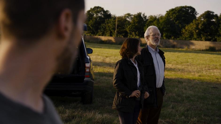 Will watches Whispers and his wife talking while watching the horses.