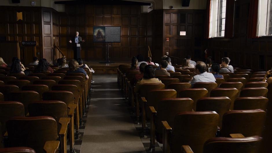 Professor Kolovi lectures a room full of students.