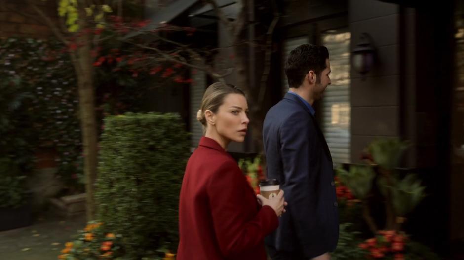 Chloe and Lucifer enter the front door of the victim's apartment building.