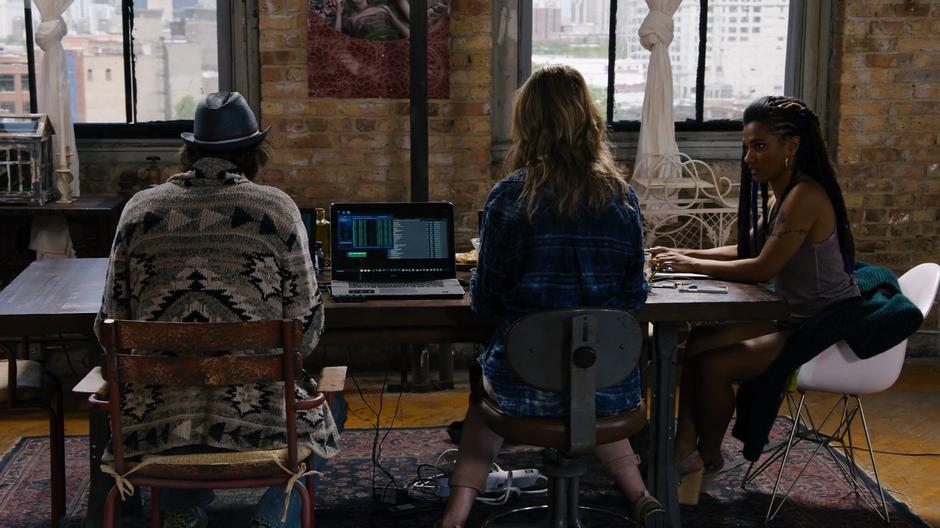 Bug, Nomi, and Amanita sit at the dining table looking up information on the venue where the gala is being held.