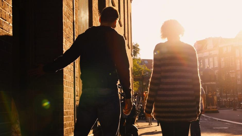 Will and Riley exit the hideout and look towards the sunset.