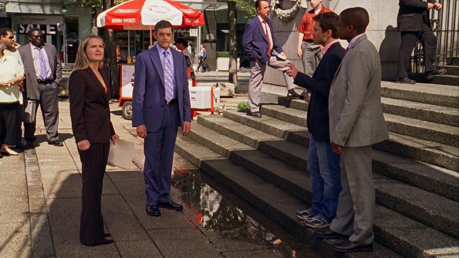 Shawn and Gus talk to Juliet and Lassiter outside the courthouse.