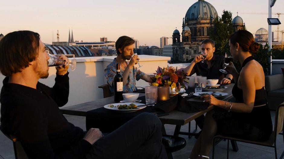 Sebastian, Felix, Wolfgang, and Lila all drink a toast.