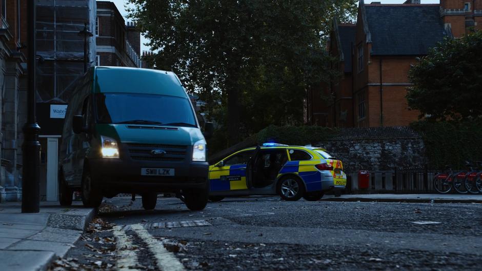 Capheus drives the BPO van around the abandoned police car and away from the BPO facility.