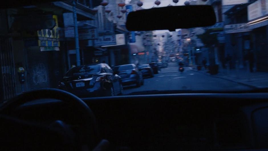 Amanita is visible through the car's windshield driving away on her motorcycle.