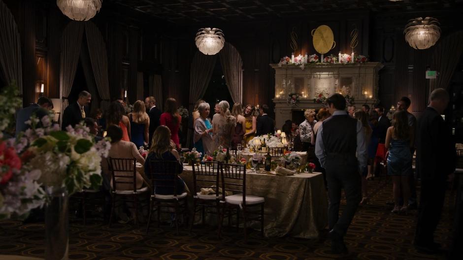 People mill around the ballroom during the rehearsal dinner.