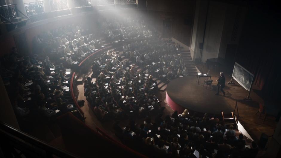 The Doctor lectures a full classroom of students about dying in space.