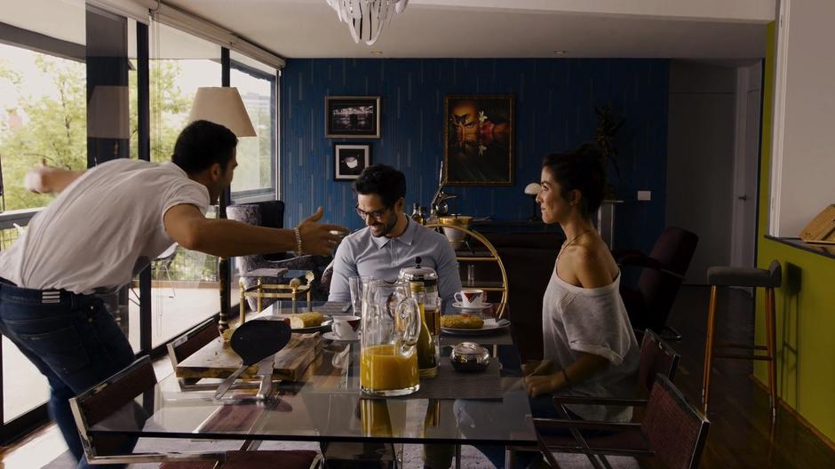 Hernando and Dani smile as Lito excitedly announces their trip to São Paulo.