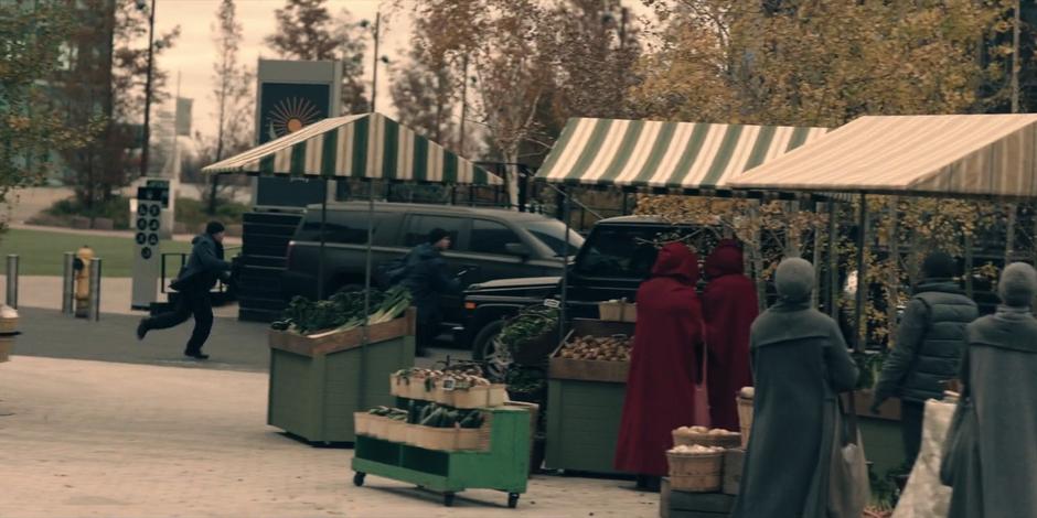 A few of the guards chase after the car Emily stole.