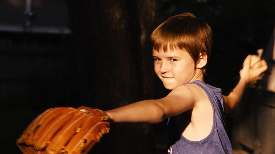 A young Will throws a baseball to his father.