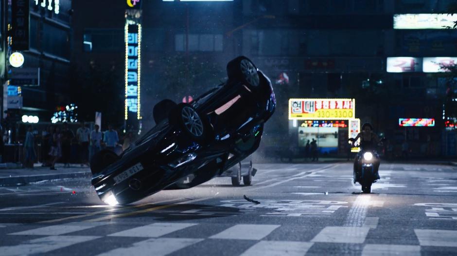 Joong-Ki's car crashes to the ground as Sun pulls her bike to a stop.