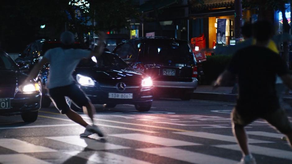 Pedestrians dive out of the way of Joong-Ki's car.