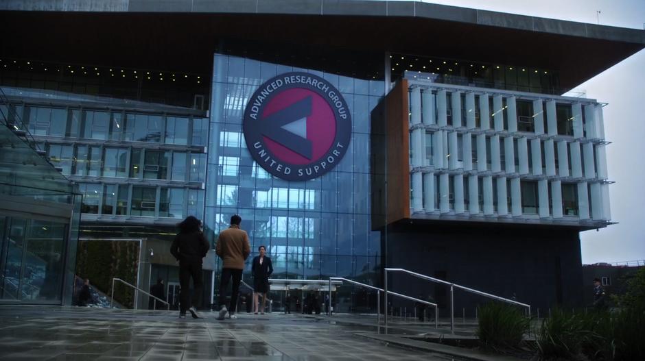 Cisco and Barry walk up to Lyla in front of the A.R.G.U.S. building.