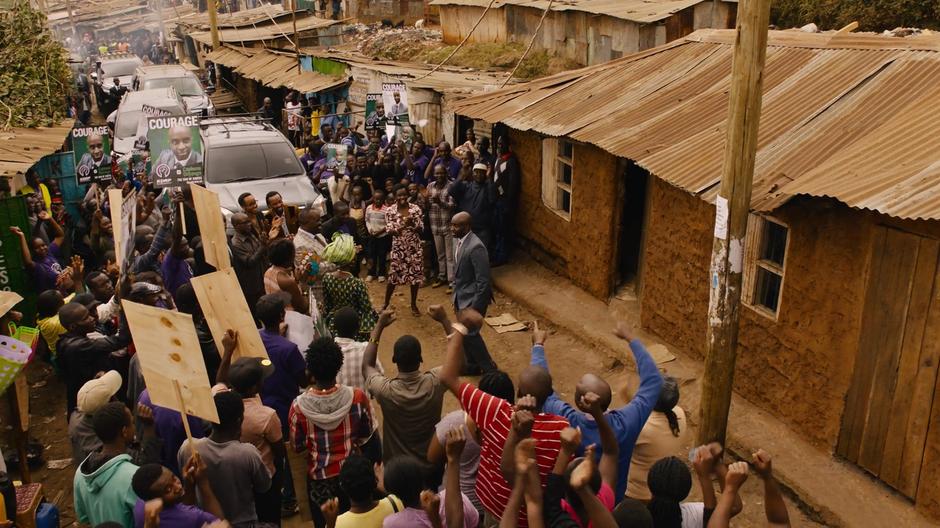 Capheus emerges from his home while the crowd applauds.