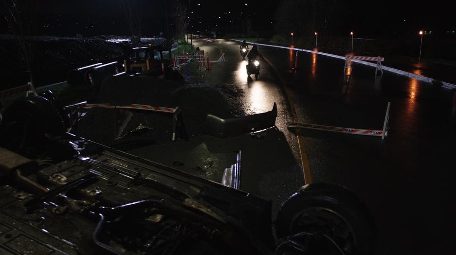 Oliver and Merlyn approach the crash site on their motorcycles.