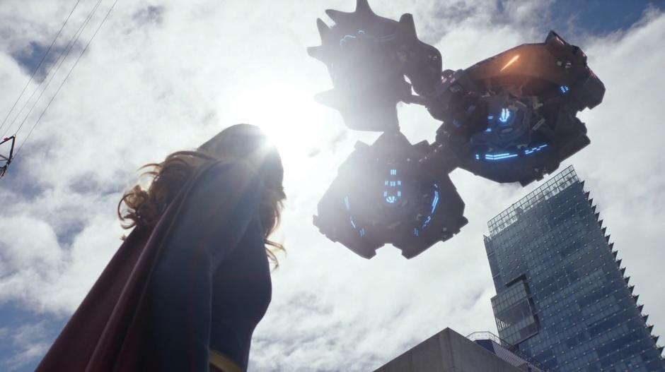 Kara looks up into the sky as the Daxamite ships begin to fire down onto the city.