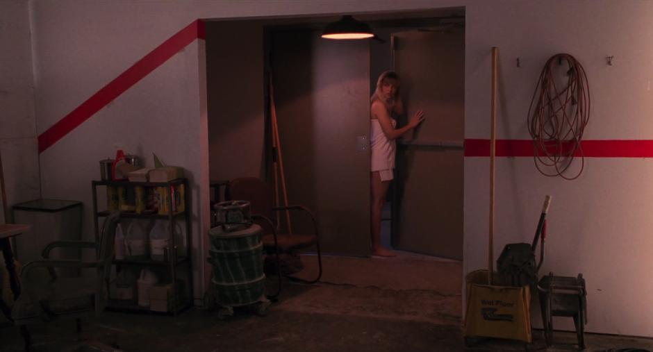 Laura enters a maintenance room in the school wearing only a towel.