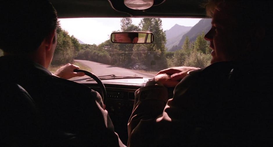 Sam and Chet chat while driving down the highway.