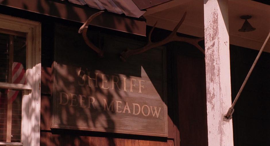 Establishing shot of the sign for the Sheriff of Deer Meadow.