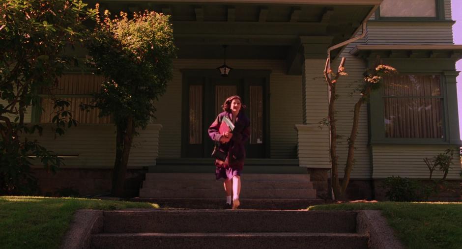 Donna runs down the steps out front of her house.