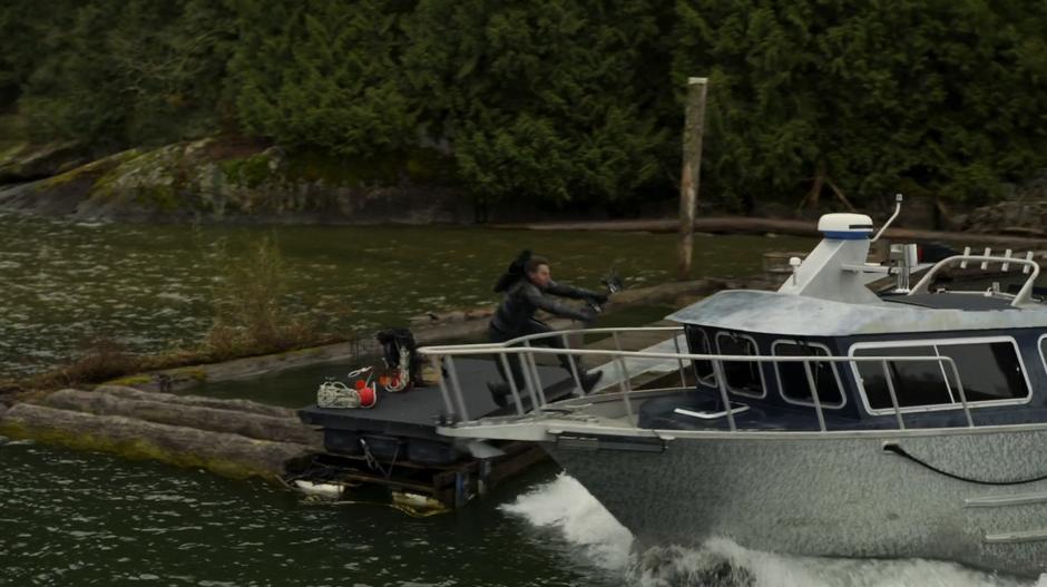 Oliver leaps from the dock onto Chase's boat.