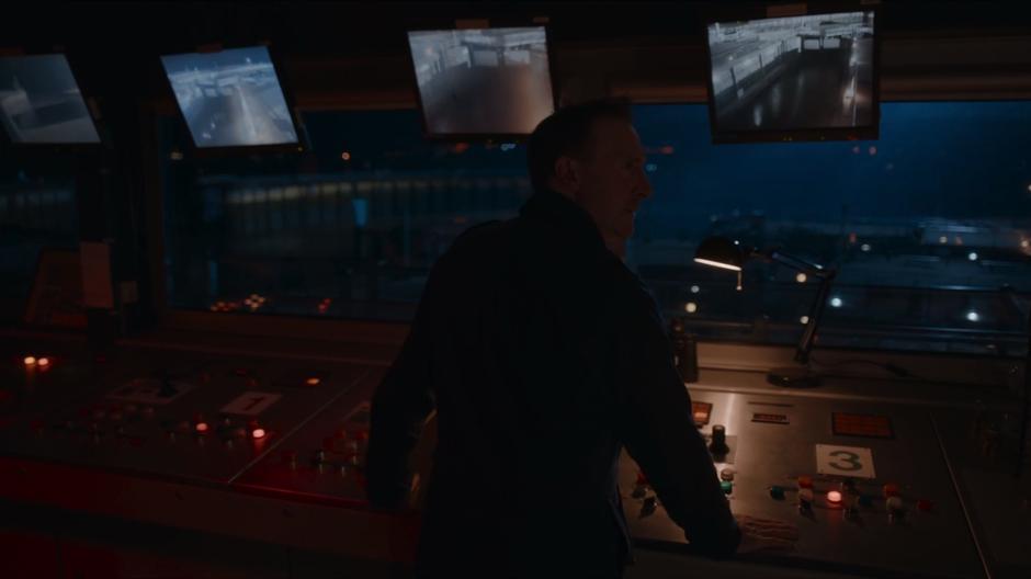 One of the pier guards looks out the window after seeing a ship approaching rapidly on sonar.