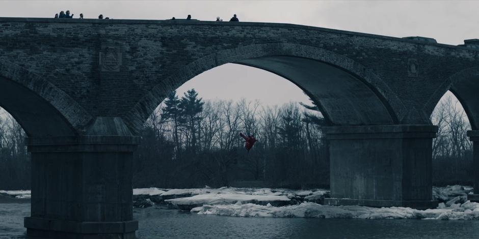 Janine falls from the bridge into the freezing waters below.