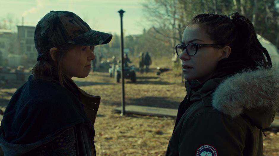 Mud shows Cosima around the camp.