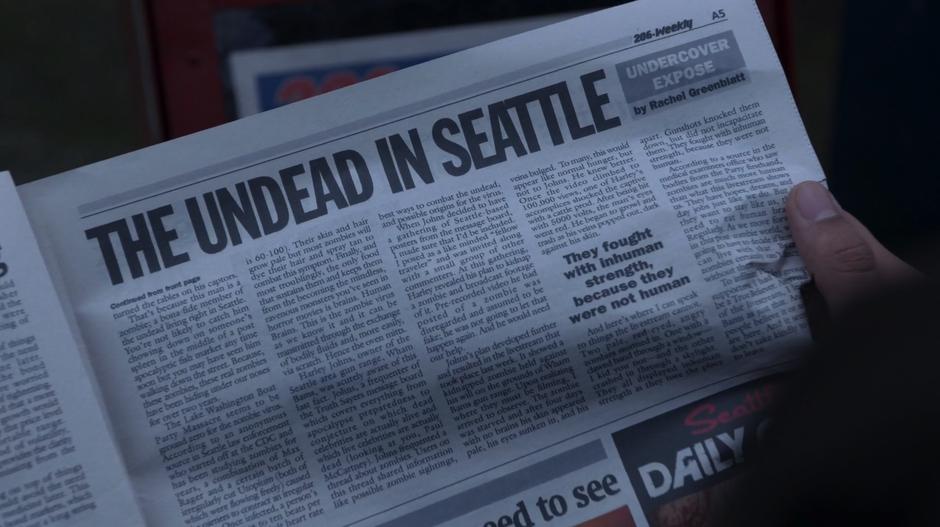 Ravi looks at the newspaper article on the zombies in Seattle.