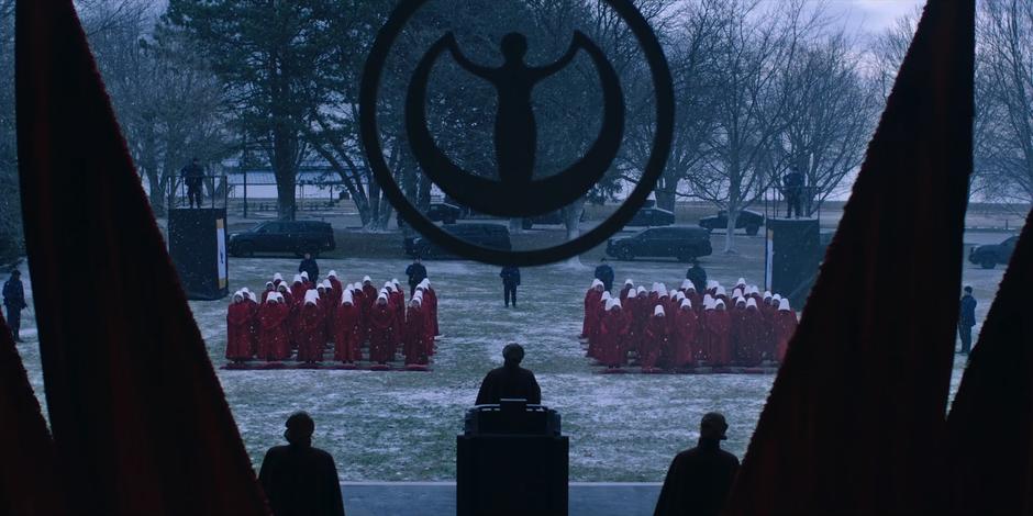 Aunt Lydia asks the handmaids to stand up and gather their stones.