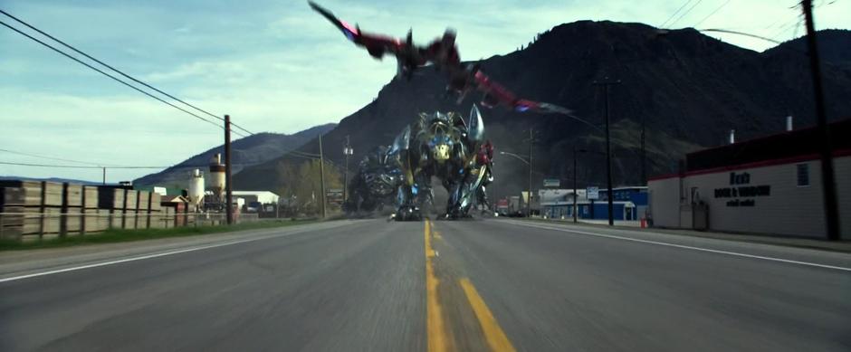 The Zords run down the street towards the camera.