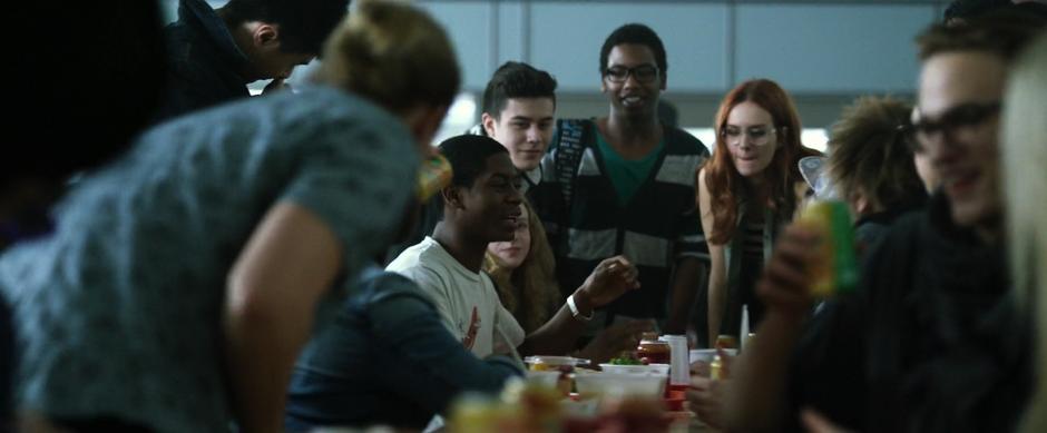 Billy holds court at the lunch table after knocking the bully out.