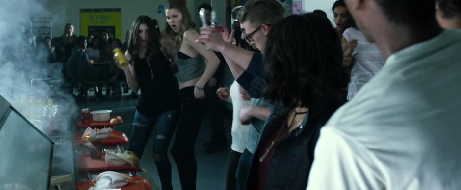 Students jump back from the counter as it becomes hot and starts melting trays and food.