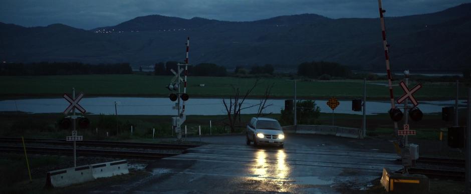 Jason and Billy drive across the railroad crossing and head up toward the mine.