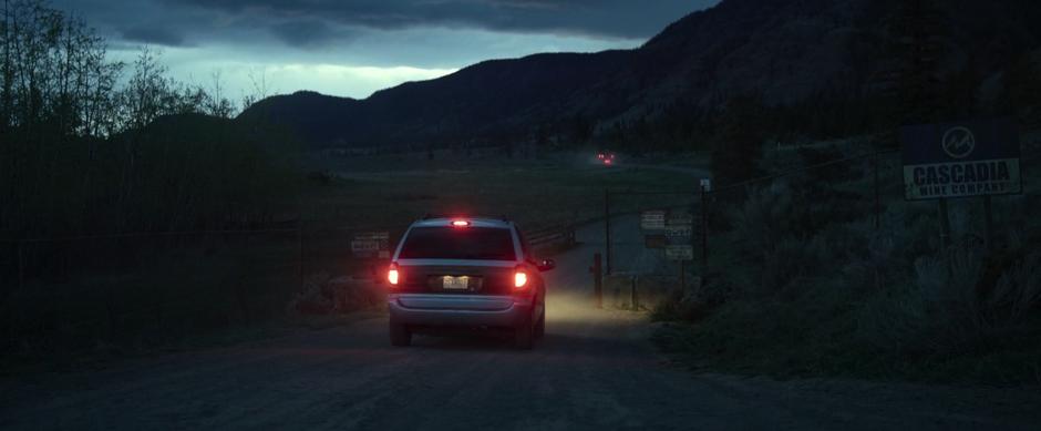 Jason stops the van in front of the gate to the mine which is covered in No Trespassing signs.