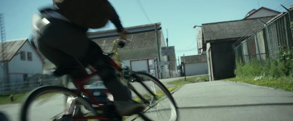 Jason jumps his bike up onto the sidewalk.