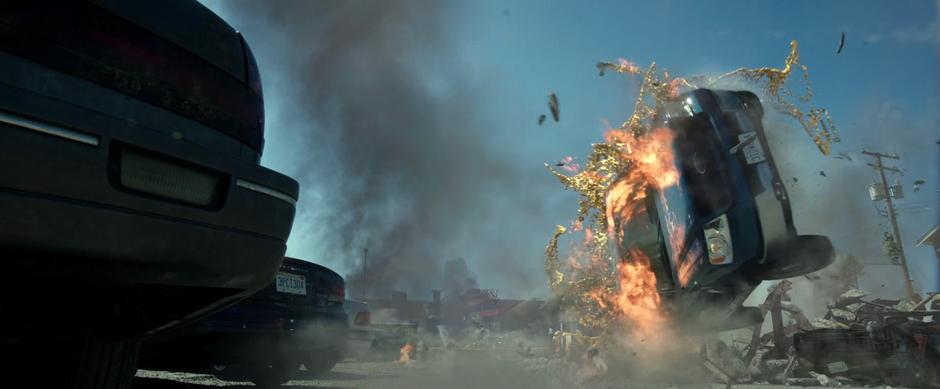 Sam's truck flips over a pile of debris while being hit by some molten gold.