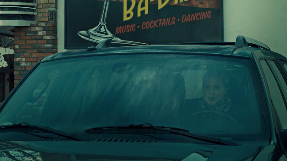 Lucado sits in her car outside the club talking to Waverly on the phone.