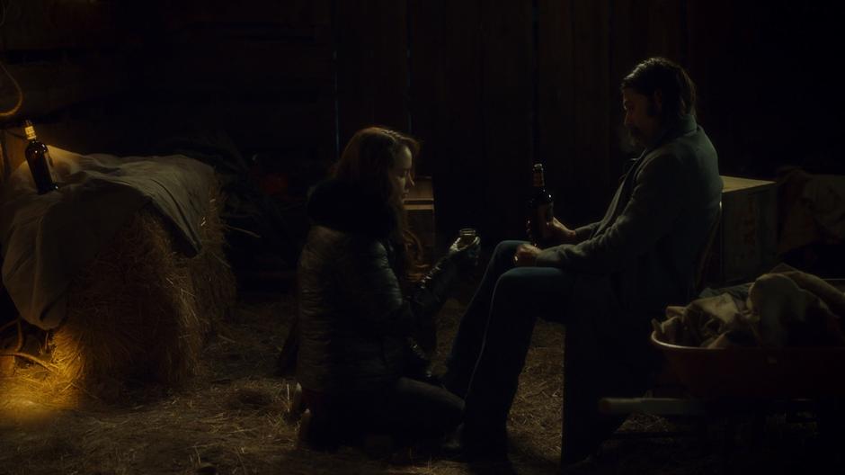 Wynonna kneels down in front of Doc in the barn.